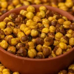 Roasted Gram, or Bengal Gram or Chana Dal, is a popular ingredient in Indian cuisine. It is a legume that high in protein, fiber, and other nutrients. Roasted Gram is a considered versatile ingredient in various type of dishes, including salads, soups, stews, and curries. Roasted Gram is also considered a great snack option because it is crunchy, tasty, and filling. This article will discuss the 10 benefits of eating Roasted Gram and how wellhealthorganic.com can help you incorporate this superfood into your diet. A rich source of protein: Roasted Gram is an excellent source of protein that thing making it an ideal food for vegetarians and vegans. Protein is essential element for building and repairing tissues, muscles, and bones. It also prove helpful to regulate hormones, enzymes, and other chemicals in the body. Roasted Gram contains about 22 grams of protein per 100 grams, higher than most other legumes. Full of plant protein: Plant protein is an excellent alternative to animal protein as it is more sustainable, ethical, and healthier. Roasted Gram is a great source of plant protein that is easy to digest and absorb. Plant protein also contains less fat, cholesterol, and calories than animal protein. Incorporating Roasted Gram into your diet can help you meet your daily protein needs without consuming too much meat. Helps manage weight / May help with weight loss: Roasted Gram is a low-calorie, high-fiber food that can help you manage weight. Fiber is essential for promoting feelings of fullness, reducing appetite, and preventing overeating. Roasted Gram contains about 17 grams of fiber per 100 grams, higher than most other legumes. Eating Roasted Grams can help you feel full for longer and reduce your overall calorie intake, leading to weight loss. Manage blood sugar levels: Roasted Gram has a low glycemic index, which means it does not cause a rapid increase in blood sugar levels. It makes it an ideal food for those with diabetes or those at risk of developing diabetes.. Roasted Gram also contains complex carbohydrates that are digested slowly, providing a steady source of energy and preventing blood sugar spikes. Protects against cardiovascular diseases: Roasted Gram is rich in antioxidants, vitamins, and minerals that benefit heart health. Antioxidants are reliable for preventing cell oxidative damage which leading to inflammation, heart disease, and other chronic diseases. Roasted Gram also rich in various ingredients such as potassium, magnesium, and folate, which help to lower blood pressure, reduce cholesterol levels, and improve blood flow. Aids in digestion: Roasted Gram is a great source of dietary fiber that helps to promote healthy digestion. Fiber helps to bulk up stools, soften them, and make them easier to pass. It can help to prevent various digestive issues, including constipation and hemorrhoids. Roasted Gram also contains digestive enzymes that help to break down food and promote nutrient absorption. Protects against cancer: Roasted Gram contains phytochemicals that have anti-cancer properties. These phytochemicals is mainly utilized to prevent the growth and spread of cancer cells, reducing the risk of developing cancer. Roasted Gram also contains saponins, which have been shown to inhibit the growth of tumors in the colon and other parts of the body. Prevention of Iron Deficiency: Roasted Gram is a good source of iron, which is essential for producing hemoglobin in the blood. Hemoglobin is the main protein that use to carries oxygen to the cells in the body. Iron deficiency can lead to anemia, fatigue, weakness, and other health issues. Eating Roasted Gram can help to prevent iron deficiency and promote healthy blood cells.